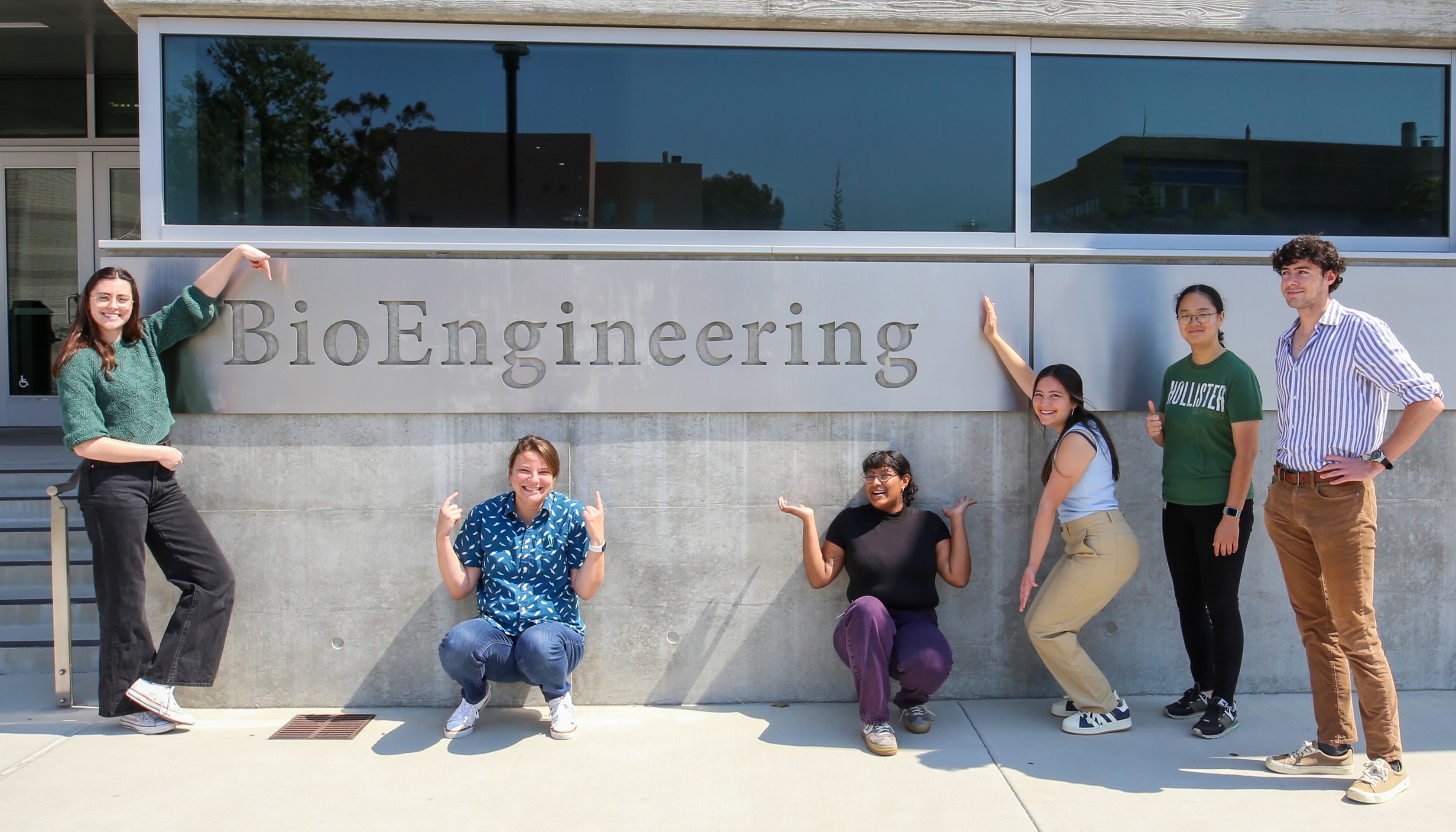 Mills research lab members smiling in front of the bioengineering building at UCSB
